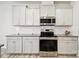 This kitchen showcases stainless steel appliances, granite counters, white cabinets, and subway tile backsplash at 15119 Oleander Dr, Charlotte, NC 28278