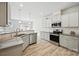 This bright kitchen features stainless appliances, granite counters, white cabinets, and an open concept design at 15119 Oleander Dr, Charlotte, NC 28278