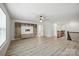 Open-concept living room with hardwood floors, custom built-ins, and a staircase at 15119 Oleander Dr, Charlotte, NC 28278