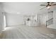 Open-concept area showcasing a kitchen, staircase, and a light-filled living room at 15119 Oleander Dr, Charlotte, NC 28278