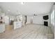 Open floor plan showcases a bright living area with a kitchen bar and easy access to the staircase at 15119 Oleander Dr, Charlotte, NC 28278