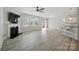 Open-concept living area features a fireplace, large windows, and a door leading to the outside at 15119 Oleander Dr, Charlotte, NC 28278