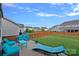 Relaxing backyard with an expansive green lawn, seating area, and fenced perimeter at 1527 Scarbrough Sw Cir, Concord, NC 28025