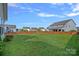 Expansive backyard with green lawn enclosed by a wooden fence, offering privacy at 1527 Scarbrough Sw Cir, Concord, NC 28025