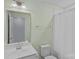 Simple bathroom with a white vanity and mirror, a toilet, and a white shower curtain at 1527 Scarbrough Sw Cir, Concord, NC 28025