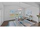 Bright dining room with natural light, stylish table setting, and hardwood floors at 1527 Scarbrough Sw Cir, Concord, NC 28025