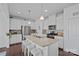 Modern kitchen with white cabinets, granite countertops, stainless steel appliances, and a large island with seating at 1527 Scarbrough Sw Cir, Concord, NC 28025