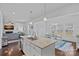 Bright kitchen featuring a large island, stainless steel appliances, and open concept layout to the dining and living areas at 1527 Scarbrough Sw Cir, Concord, NC 28025