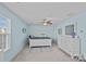 Spacious primary bedroom features blue walls, carpeted floor, ceiling fan, lots of natural light and a dresser with a mirror at 1527 Scarbrough Sw Cir, Concord, NC 28025