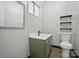 Well-lit bathroom featuring a green vanity and patterned wall accents providing a functional yet fashionable space at 1535 Maplewood Ave, Lancaster, SC 29720
