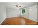 Bedroom features hardwood floors, gray walls, and a ceiling fan, providing a serene and comfortable space to relax at 1535 Maplewood Ave, Lancaster, SC 29720