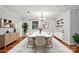 Modern dining room with stylish table, chairs, wood floors, and buffet, creating an ideal space for Gathering gatherings at 1535 Maplewood Ave, Lancaster, SC 29720