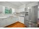 Well-lit kitchen featuring white cabinets, stainless steel appliances, and wooden flooring, adding style and functionality at 1535 Maplewood Ave, Lancaster, SC 29720