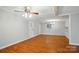 Large, bright living room with original hardwood flooring, fresh paint, and new ceiling, perfect for entertaining and relaxation at 1535 Maplewood Ave, Lancaster, SC 29720
