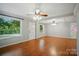 Spacious living room features hardwood floors, a new ceiling, fresh gray paint, and large windows for natural light at 1535 Maplewood Ave, Lancaster, SC 29720
