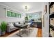 This home office is bathed in natural light and includes modern furnishings and a decorative light fixture at 1535 Maplewood Ave, Lancaster, SC 29720