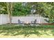 Relaxing backyard featuring a cozy fire pit area with Adirondack chairs and lush greenery at 15838 Trenton Place Rd, Huntersville, NC 28078