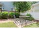 Inviting backyard featuring a patio with an outdoor dining table and lush landscaping at 15838 Trenton Place Rd, Huntersville, NC 28078