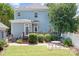 Backyard features a well-manicured lawn, patio area, and deck for entertaining with plenty of space to run and play at 15838 Trenton Place Rd, Huntersville, NC 28078