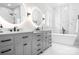Luxurious bathroom features double vanities, modern lighting, a soaking tub, and elegant marble finishes at 15838 Trenton Place Rd, Huntersville, NC 28078