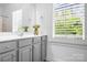 Well-lit bathroom with neutral paint, sleek vanity, stylish cabinets, and a large window at 15838 Trenton Place Rd, Huntersville, NC 28078