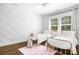 Bright bedroom featuring stylish twin beds, unique accent wall, and light hardwood flooring at 15838 Trenton Place Rd, Huntersville, NC 28078