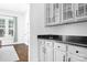 Butler's pantry with white cabinets, granite countertops, and glass-front cabinets at 15838 Trenton Place Rd, Huntersville, NC 28078