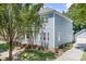 Charming two-story home with blue siding, white trim, landscaped yard, and paved driveway at 15838 Trenton Place Rd, Huntersville, NC 28078
