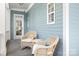 Inviting front porch with wicker chairs and a small table, perfect for relaxing and enjoying the neighborhood views at 15838 Trenton Place Rd, Huntersville, NC 28078