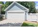 Attached garage with white door, exterior lighting, and complementary blue siding at 15838 Trenton Place Rd, Huntersville, NC 28078
