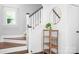 Welcoming hallway with wood floors, stairs, and a stylish table with plants, offering a cozy ambiance at 15838 Trenton Place Rd, Huntersville, NC 28078