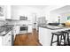 Modern kitchen with stainless steel appliances, white cabinets, and a center island with seating at 15838 Trenton Place Rd, Huntersville, NC 28078