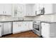 Bright kitchen with white cabinets, stainless steel appliances, and dark countertops at 15838 Trenton Place Rd, Huntersville, NC 28078