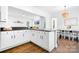 Open kitchen with white cabinets, dark countertops, and a view into the dining area at 15838 Trenton Place Rd, Huntersville, NC 28078