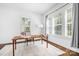 Bright office space features a large window, hardwood floors, and a simple wooden desk and chair at 15838 Trenton Place Rd, Huntersville, NC 28078