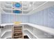 Walk-in pantry with custom shelving, stylish wallpaper, and a wine refrigerator at 15838 Trenton Place Rd, Huntersville, NC 28078