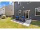 Inviting backyard patio with comfortable seating, a modern rug, and easy access to the home through a sliding glass door at 169 Rooster Tail Ln, Troutman, NC 28166
