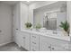 Bathroom with double sinks, white cabinets, and a large mirror at 169 Rooster Tail Ln, Troutman, NC 28166
