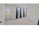 Bright bedroom with three windows and plush carpeting at 169 Rooster Tail Ln, Troutman, NC 28166