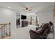 Bonus room with a ceiling fan, leather chair, television, and an open doorway to the laundry room at 169 Rooster Tail Ln, Troutman, NC 28166