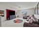 Entertainment room features a large leather couch, fun decor, and large TV perfect for Gathering movie nights at 169 Rooster Tail Ln, Troutman, NC 28166
