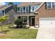 Lovely home featuring brick and gray siding, well-maintained landscaping, covered porch, and a convenient two-car garage at 169 Rooster Tail Ln, Troutman, NC 28166