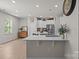Bright, open kitchen featuring an island with counter seating, stainless steel appliances, and elegant white cabinetry at 169 Rooster Tail Ln, Troutman, NC 28166