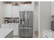 Kitchen area featuring stainless steel refrigerator and white cabinets at 169 Rooster Tail Ln, Troutman, NC 28166