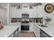 Well-equipped kitchen with stainless steel appliances, white cabinets, stone countertops, and a stylish subway tile backsplash at 169 Rooster Tail Ln, Troutman, NC 28166