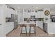 Modern kitchen featuring white cabinets, stainless steel appliances, a central island, and stylish bar stool seating at 169 Rooster Tail Ln, Troutman, NC 28166