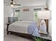 Main bedroom featuring a large bed with two windows for natural light at 169 Rooster Tail Ln, Troutman, NC 28166