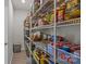 Walk-in pantry with wire shelving stocked with food items and storage containers at 169 Rooster Tail Ln, Troutman, NC 28166