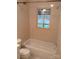 Standard bathroom with a tiled shower-tub combo and toilet at 1700 Old Spencer Mountain Rd, Dallas, NC 28034