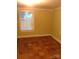 Bright bedroom featuring hardwood floors and a window providing natural light at 1700 Old Spencer Mountain Rd, Dallas, NC 28034